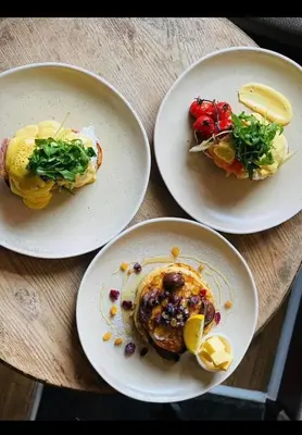 three plates of food on a wooden table at The Hinds Head Hotel in Chorley