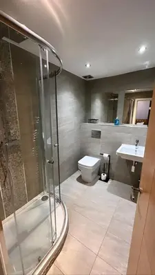 a bathroom with a shower and a toilet and a sink at The Hinds Head Hotel in Chorley