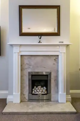 a fireplace with a mirror on top of it at Bedzzz - Booklovers Dream in Preston