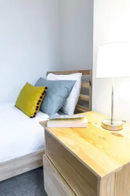 a bedroom with a bed with a desk with a keyboard at Bedzzz - Booklovers Dream in Preston