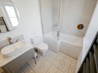 a bathroom with a toilet and a sink and a shower at Dunmail House in Grange Over Sands