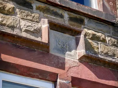 a sign on the side of a brick building at Dunmail House in Grange Over Sands