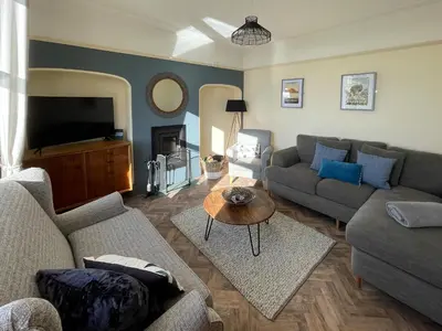 a living room with a couch and a tv at Dunmail House in Grange Over Sands