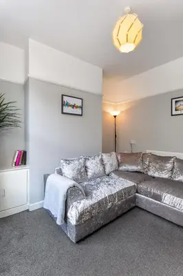 a living room with a couch and a table at Comfortable Liverpool Townhouse - Close to City & Stadium in Liverpool