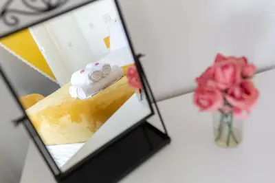 a mirror with a picture of a cake and roses at Comfortable Liverpool Townhouse - Close to City & Stadium in Liverpool