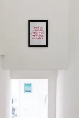a picture frame hanging on a wall above a door at Comfortable Liverpool Townhouse - Close to City & Stadium in Liverpool