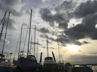 a group of boats docked in a harbor with a cloudy sky at Beautiful Loft City Centre, Liverpool 1 in Liverpool