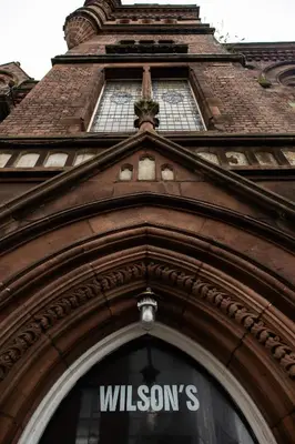 a building with a window with the words wilsons on it at Malacuna Liverpool in Liverpool