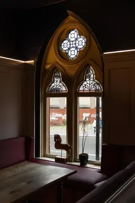 a room with two windows and a table with a plant at Malacuna Liverpool in Liverpool
