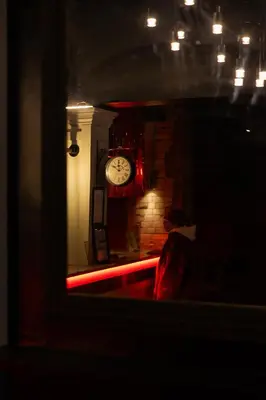 a dark room with a clock on a wall at Malacuna Liverpool in Liverpool