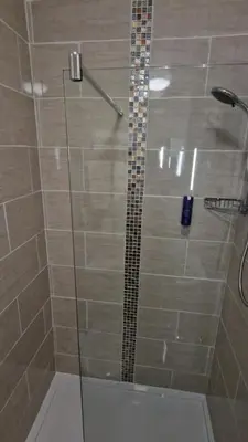 a shower stall with a glass door with a shower at Corona Blackpool in Blackpool