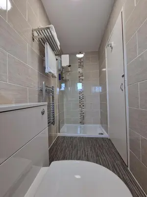 a bathroom with a shower and a tub at Corona Blackpool in Blackpool