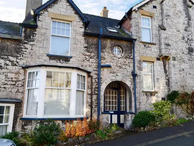 an old stone house with white windows at Lythdene in Grange Over Sands