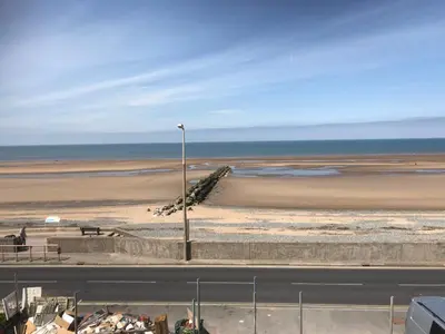 a beach with a street light and the ocean at Beach Pad - ground floor - pet friendly in Cleveleys