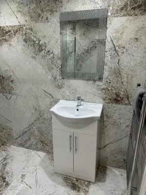 a bathroom with a sink and a mirror on a wall at Beach Pad - ground floor - pet friendly in Cleveleys