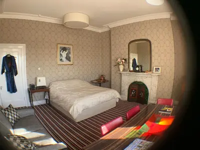 a bedroom with a bed and a fireplace at Aberley House in Liverpool