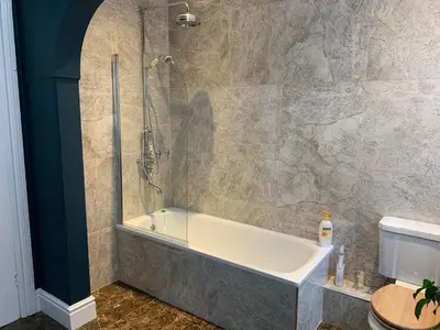 a bathroom with a bath tub and a shower at Aberley House in Liverpool
