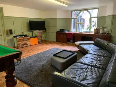 a living room with a couch and a pool table at Aberley House in Liverpool