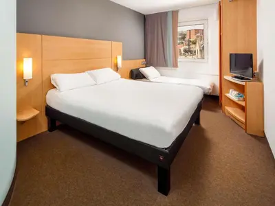 a hotel room with two beds and a television at ibis Liverpool Centre Albert Dock – Liverpool One in Liverpool