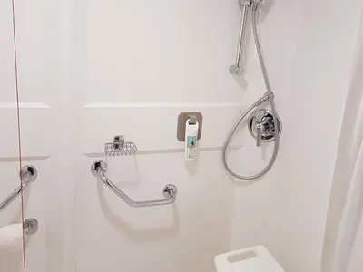a white bathroom with a shower and a toilet at ibis Liverpool Centre Albert Dock – Liverpool One in Liverpool