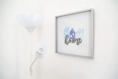 a picture of a house on a wall with a lamp at Ropewalks Apartments by Happy Days in Liverpool