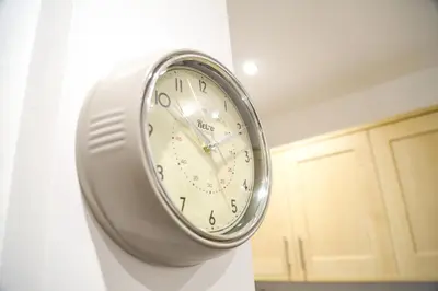 a clock hanging on a wall in a kitchen at Ropewalks Apartments by Happy Days in Liverpool