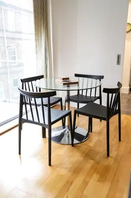 a table and two chairs and a table and a window at Ropewalks Apartments by Happy Days in Liverpool