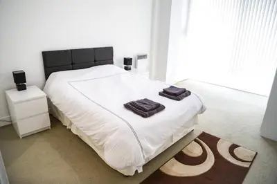 a bedroom with a bed with two towels on it at Ropewalks Apartments by Happy Days in Liverpool