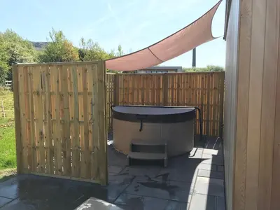 a backyard with a fence and a hot tub at Parkknott Retreat Luxury Lodge with Private Hot Tub in Askam in Furness
