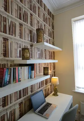 a laptop on a desk in front of a wall of books at The Winter Garden Suites in Blackpool