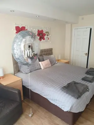 a bedroom with a bed with a balloon on it at The Winter Garden Suites in Blackpool