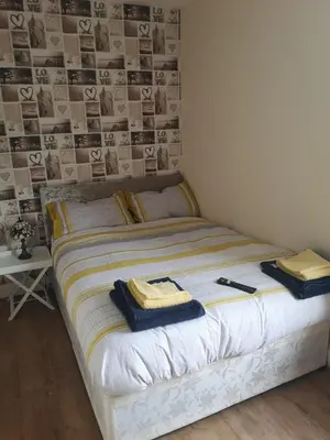 a bed with towels on it in a bedroom at The Winter Garden Suites in Blackpool