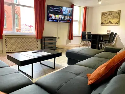 a living room with a couch and a table at Simpson Beach View Apartments by Blackpool Service Apartments in Blackpool