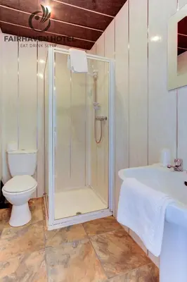 a bathroom with a shower and a toilet at Fairhaven Hotel in Blackpool