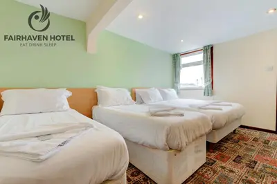 two beds sitting next to each other in a room at Fairhaven Hotel in Blackpool