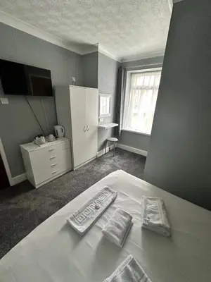 a bedroom with a bed with two towels on it at Silversands Hotel in Blackpool