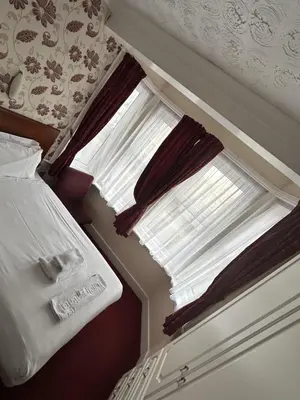 a bedroom with a bed and a window at Silversands Hotel in Blackpool