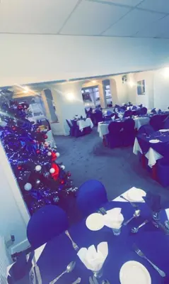 a room with tables and chairs and christmas trees at Silversands Hotel in Blackpool