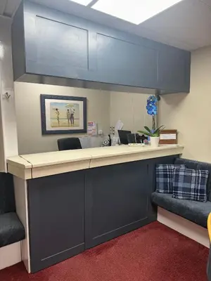 an office with a reception counter with blue cabinets at Silversands Hotel in Blackpool