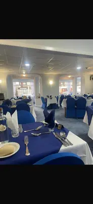 a dining room with blue and white tables and chairs at Silversands Hotel in Blackpool