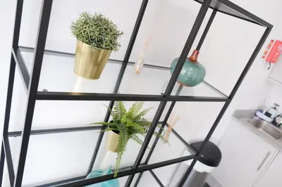 a glass shelf with potted plants on it at The Seacroft in Southport