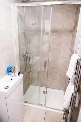 a shower with a glass door in a bathroom at The Seacroft in Southport