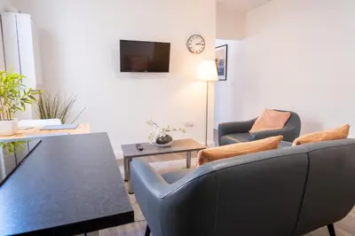 a living room with two chairs and a table at The Seacroft in Southport