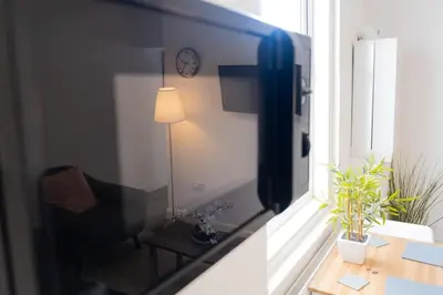 a view of a living room from a window with a television at The Seacroft in Southport