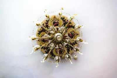 a gold and white circular object on a white background at MyRoomz Hollingdales Hotel in Blackpool