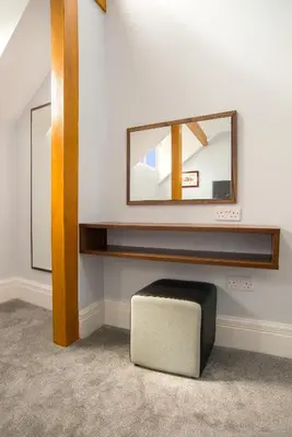 a mirror on a wall with a stool in a room at The Castle Collection - 42 Castle Street in Liverpool