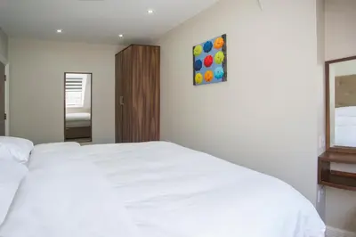 a bedroom with a white bed and a painting on the wall at The Castle Collection - 42 Castle Street in Liverpool