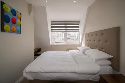 a white bed in a bedroom with a window at The Castle Collection - 42 Castle Street in Liverpool