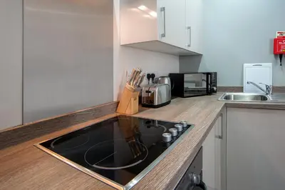 a kitchen with a sink and a stove top oven at The Castle Collection - 42 Castle Street in Liverpool