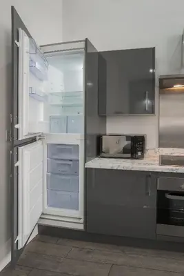 a kitchen with an empty refrigerator with its door open at The Castle Collection - 42 Castle Street in Liverpool